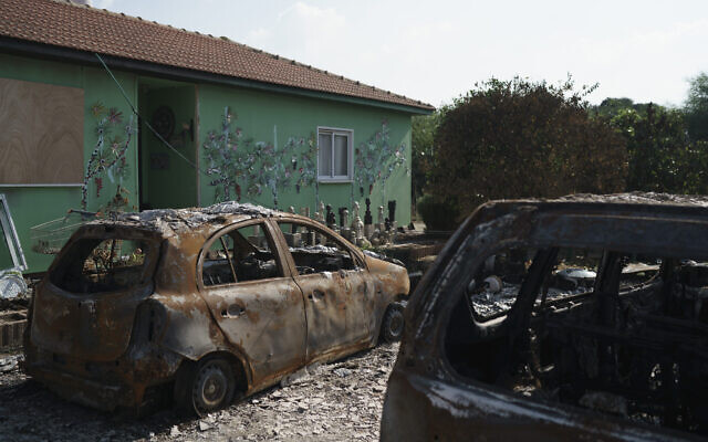 Burned cars are seen at moshav Netiv Ha'asara near the border with Gaza Strip, November 17, 2023, after the Israeli community was attacked during the Hamas cross-border onslaught on October 7. (AP Photo/Leo Correa)