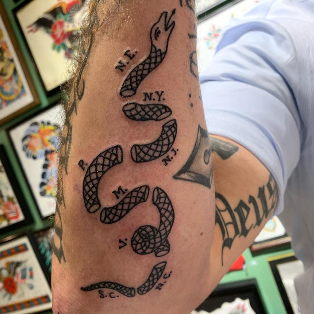 Pete Hegseth shows off the "Join, Or Die" snake cartoon.