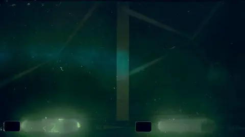 NOC The shot shows a structure through the gloom of the loch's waters