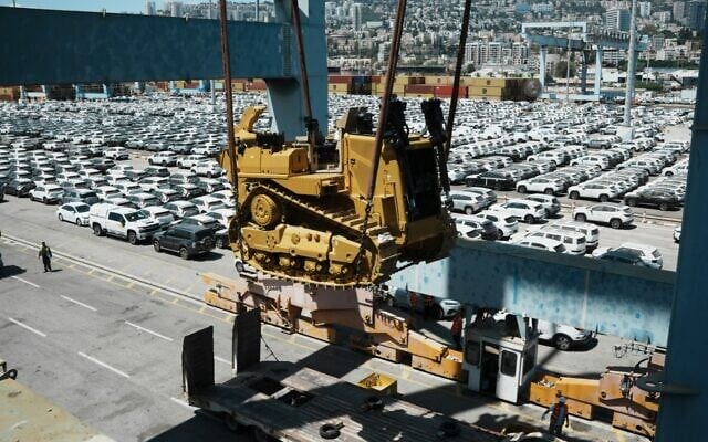Caterpillar D9 bulldozers are unloaded from a ship at Haifa Port, July 9, 2025. (Defense Ministry)