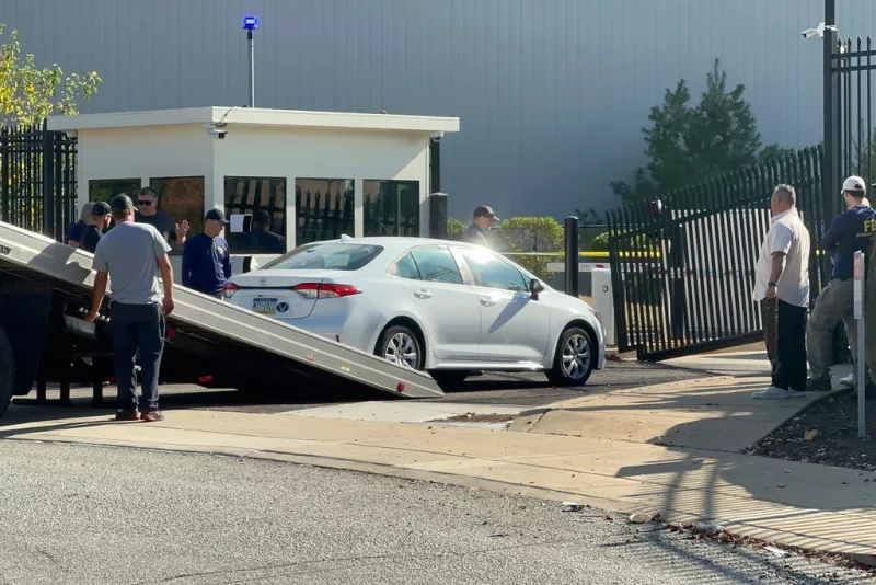 A car that rammed into a gate at the FBI building is removed in Pittsburgh