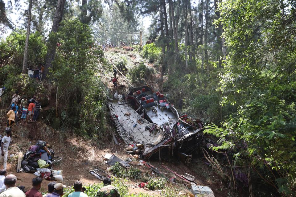 Rescue workers search for survivors at a bus crash site in Sri Lanka.