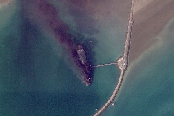 This satellite image from Planet Labs PBC shows fires burning on a ship after a U.S. military attack on a port in Bandar Abbas, Iran, March 2, 2026. (Planet Labs PBC via AP)